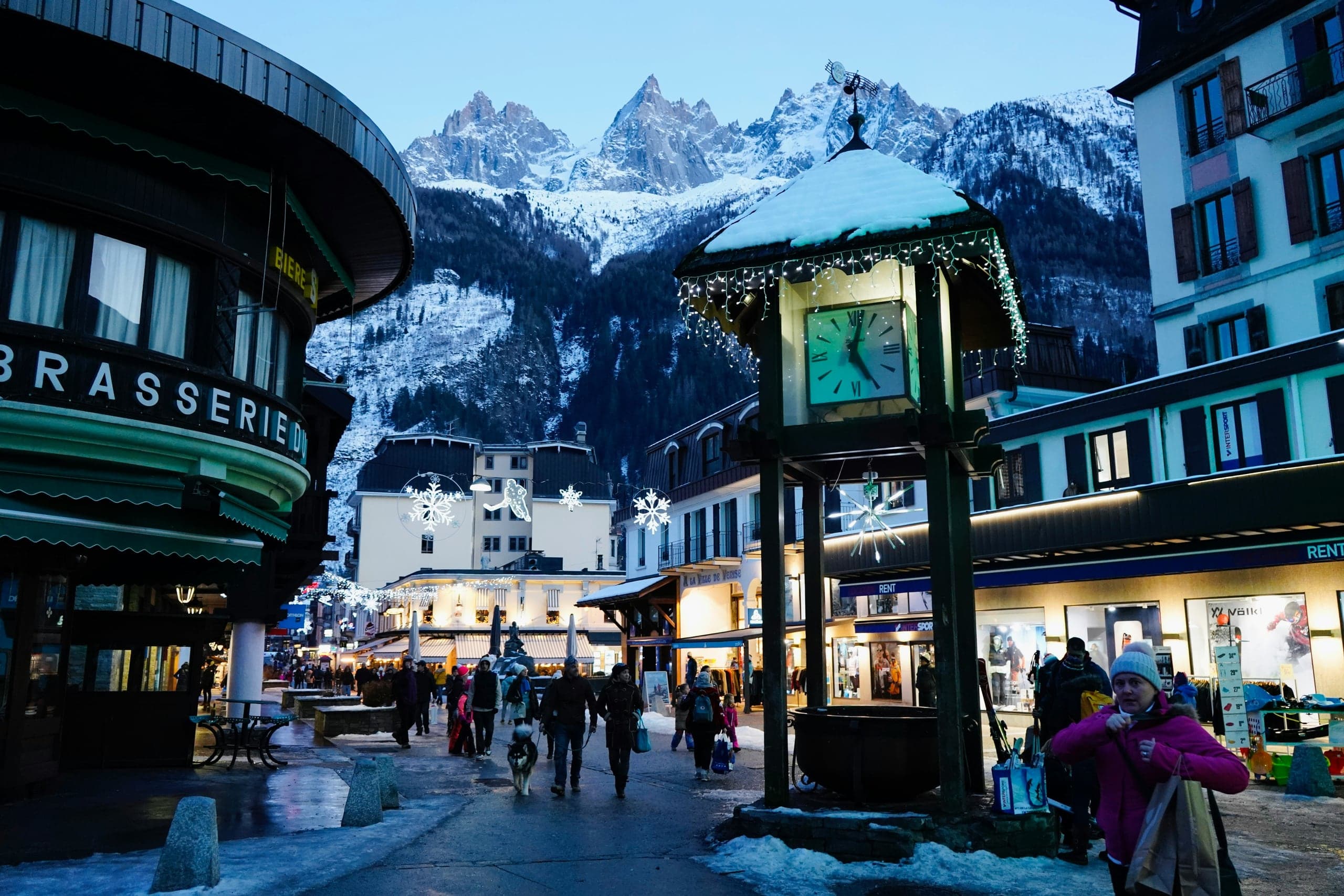 Chamonix clock tower and pedestrian center beneath snowy Alpine peaks
