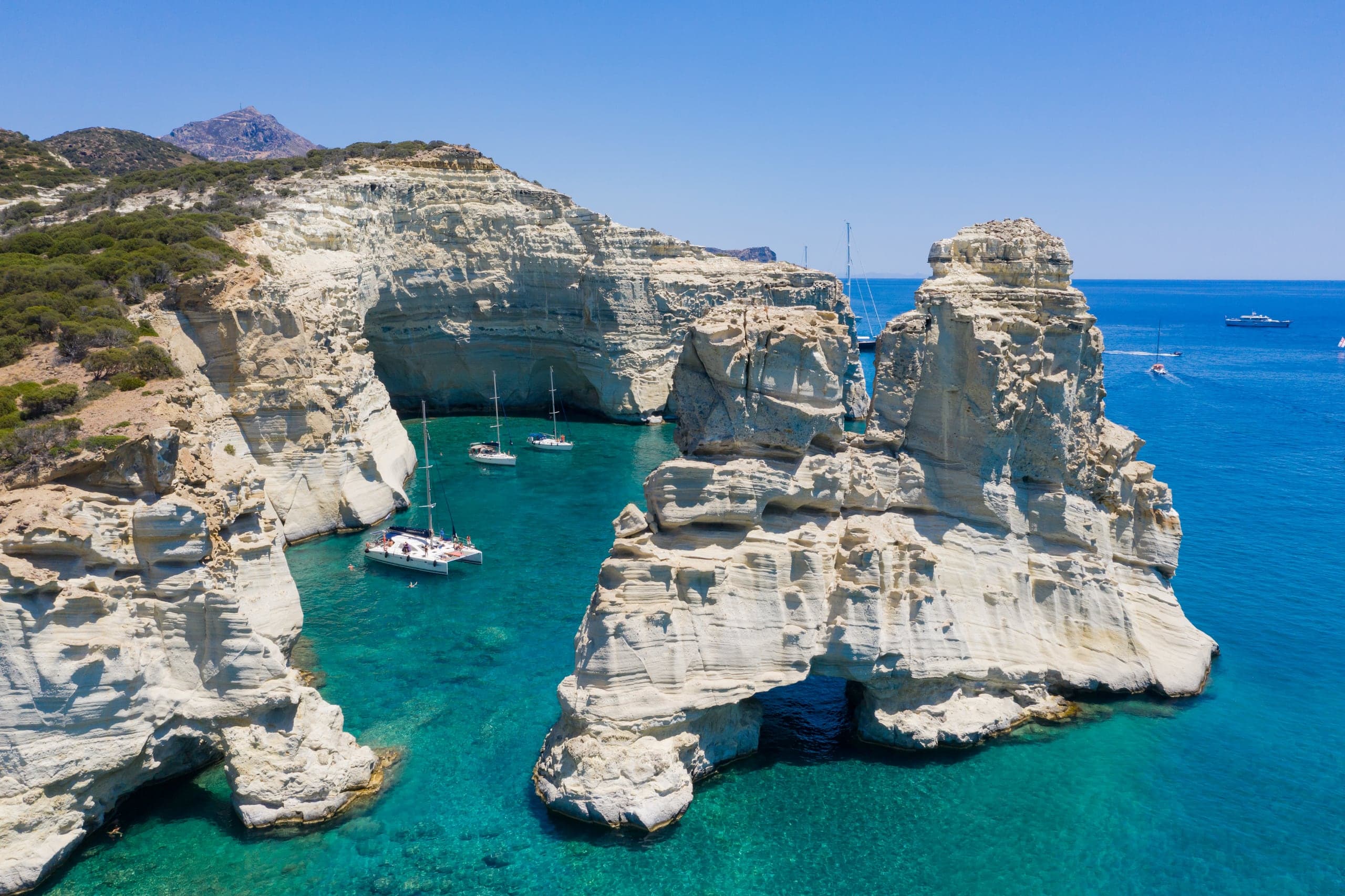 Yachts in turquoise water among Kleftiko's sea caves